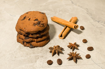 chocolate cookies with cinnamon and coffee on the table