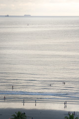 Aerial view of the seaside of the city of Santos in Brazil at sunset time when people walks in the beach relaxing and having fun