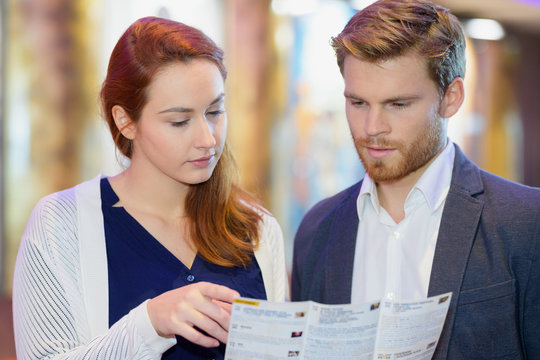 Couple Holding A Brochure