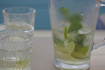 Cold lemonade with mint in a transparent decanter