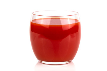 A glass of fresh tomato juice on a white isolated background