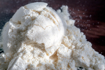 Heap of yellow banana protein powder on broun background. Top view