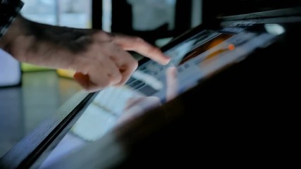 Education and technology concept - man using interactive touchscreen display of electronic kiosk at modern history museum - close up shot