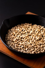 Healthy food concept roasted organic sunflower seeds in skillet iron cast for make sunflower butter