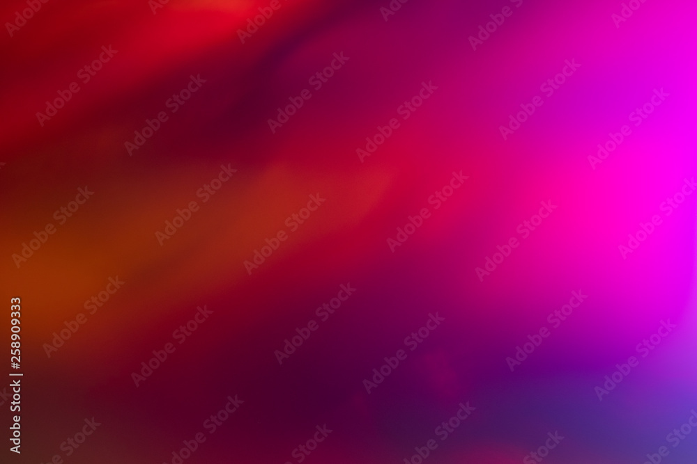 Wall mural blurred pink and red abstract lens flare background. defocused glow effect. illuminated bokeh