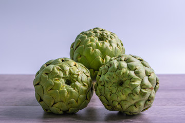 Fototapeta premium artichokes on grey background. fresh organic artichoke flower