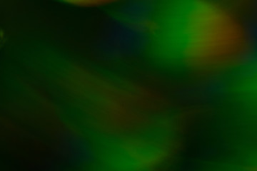 Blurry yellow light spot on dark background. Bokeh lens flare glow. Abstract design.