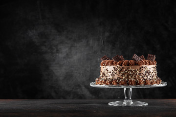 Decorated chocolate cake on dark background © George Dolgikh