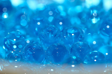 Water blue gel balls. Polymer gel. Silica gel. Balls of blue hydrogel. Crystal liquid ball with reflection. Texture background. Close up macro