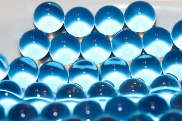 Water blue gel balls. Polymer gel. Silica gel. Balls of blue hydrogel. Crystal liquid ball with reflection. Texture background. Close up macro