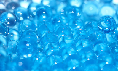 Water blue gel balls. Polymer gel. Silica gel. Balls of blue hydrogel. Crystal liquid ball with reflection. Texture background. Close up macro