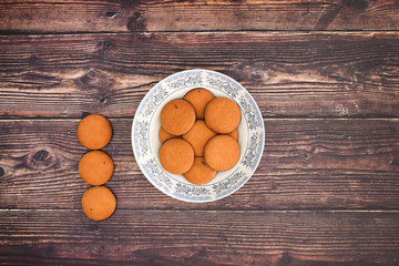 Cookies in plate on wooden background