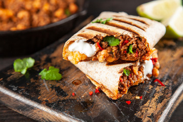 Mexican burrito with beef, beans and sour cream