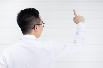 Asian smart and handsom business man in white shirt pointing his finger in the front close up.