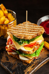 Tall club sandwich and french fries