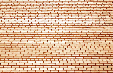 Pattern of brick wall with blur effect in orange tone.