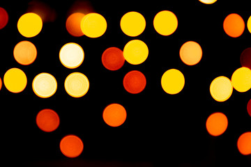 Unfocused abstract gold bokeh on black background. defocused and blurred many round light