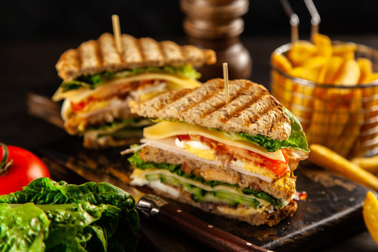 Tall club sandwich and french fries