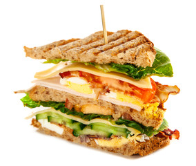 Tall club sandwich with eggs, turkey and bacon