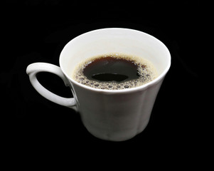 A Cup of coffee made of white ceramic with a film isolated on a black background.