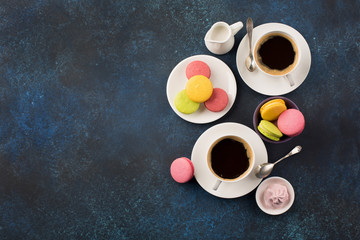 Two cups of coffee and sweets on table