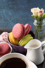 Cup of coffee and sweets on table