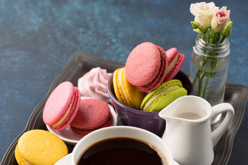 Cup of coffee and sweets on table