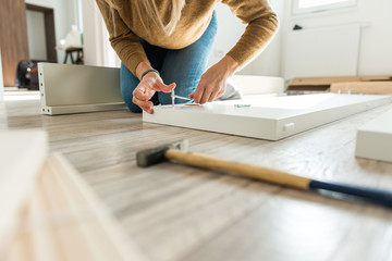 Females hands screwing a screw