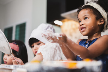 Group diversity kids girl making cake bakery in kitchen