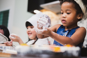 Group diversity kids girl making cake bakery in kitchen