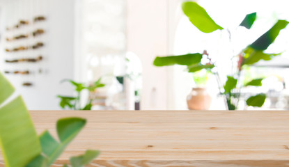 Blurred interior of tropical resort in front of wooden tabletop