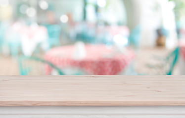 Defocused background of restaurant with wooden table top in front