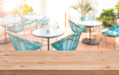 Wood table top on blur background of cafe or restaurant