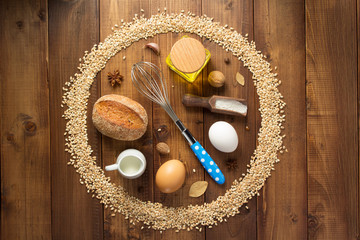 wheat grains and bakery ingredients on wood