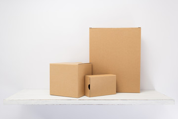 cardboard box on wooden shelf