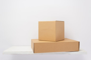 cardboard box on wooden shelf