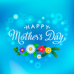 Naklejka na ściany i meble Handmade elegant inscription Happy Mother's Day on blurred blue sky background with wildflowers.Vector illustration