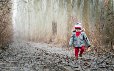 Smiling baby boy walking in the wood