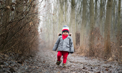 Smiling baby boy walking in the wood