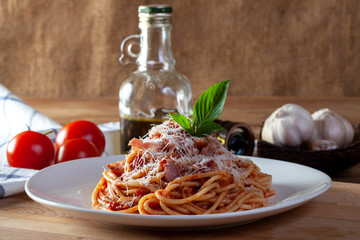 Spaghetti in a dish on a wooden background