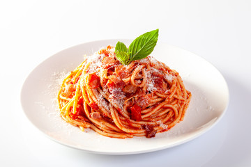 Spaghetti in a dish on a white background - obrazy, fototapety, plakaty