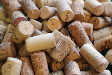 Wine bottle and corks on green background, somelie tools
