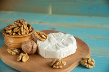 Obraz na płótnie Canvas Cheese camembert or brie with walnut kernels