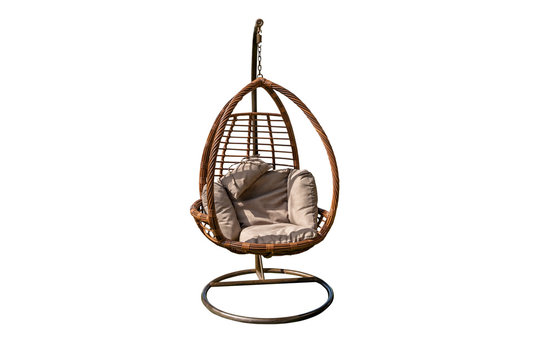 Wicker hanging chair ,swing hanging on a chain with orang cushions orange pillow isolated on white background with clipping path