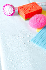 Vertical shot.Cleaning items on the blue wet surface after housework.Empty space for your text.Concept of clean and orderly