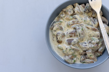 Curry mushrooms with creamy sauce on gray wooden background. Healthy eating or vegetarian concept. Copy space. Top view