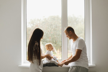 Mom and dad play with their little son