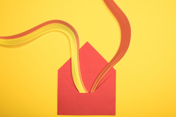 top view of opened red envelope with rainbow on yellow background