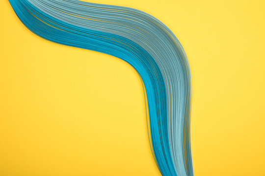 top view of curved blue lines on yellow background
