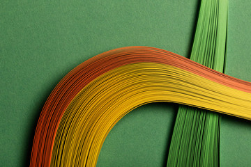 close up of multicolored abstract lines on green background